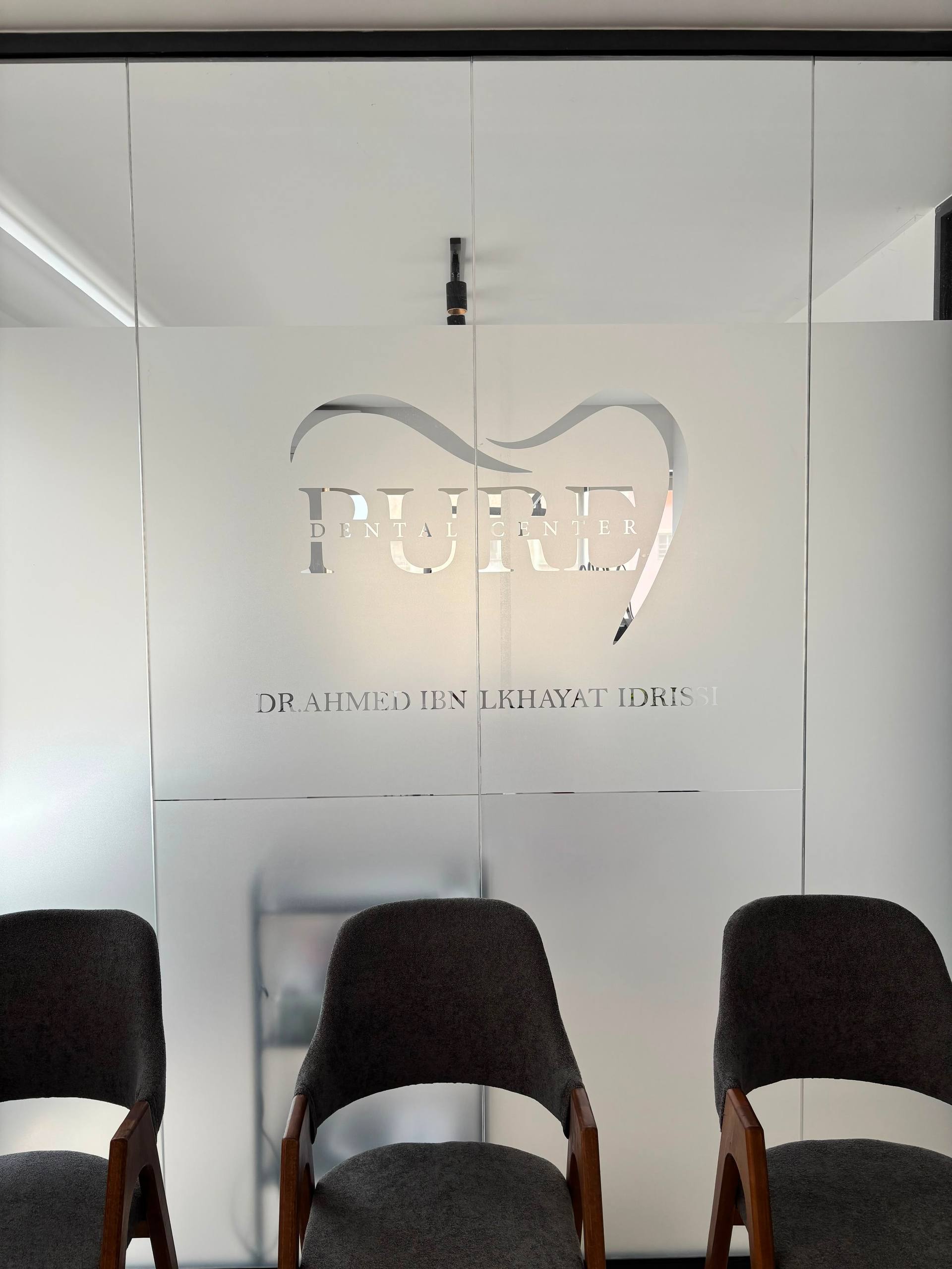 Signature Pure Dental Center gravée sur la verrière du cabinet